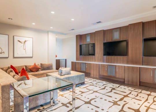 a living room with a couch and a glass table  at The Acadia at Metropolitan Park, Arlington, VA